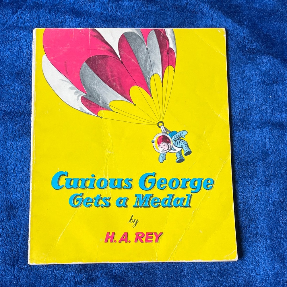 Scholastic Curious George Gets a Medal - Yellow and Red Cover